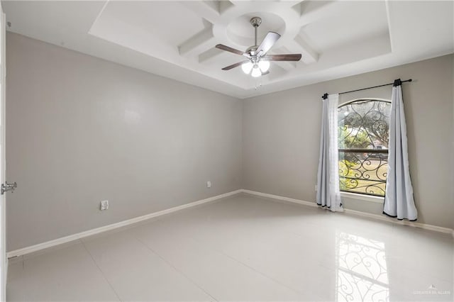 empty room featuring coffered ceiling, tile patterned flooring, a raised ceiling, and ceiling fan