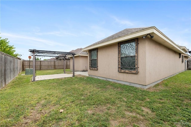 rear view of property with a yard, a pergola, and a patio