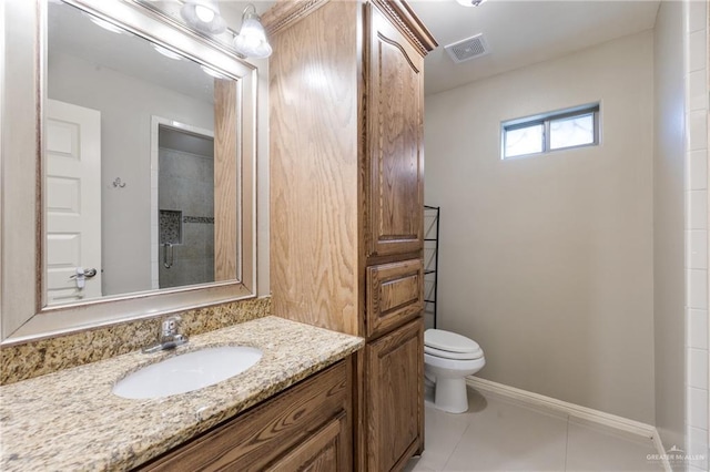 bathroom featuring tile patterned flooring, vanity, a shower, and toilet