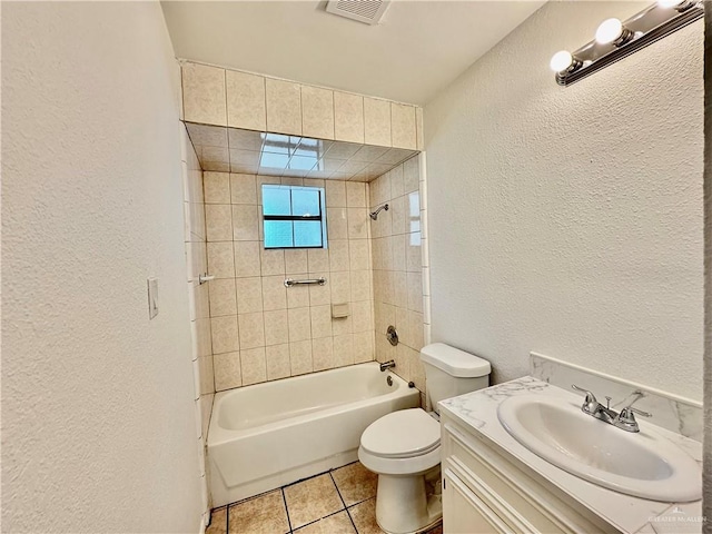1313 Royal Palm St, Alamo, TX 78516 - bathroom featuring a textured wall, vanity, toilet, bathing tub / shower combination, and tile patterned floors
