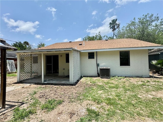 1313 Royal Palm St, Alamo, TX 78516 - back of house featuring central AC, a patio area, brick siding, and a lawn