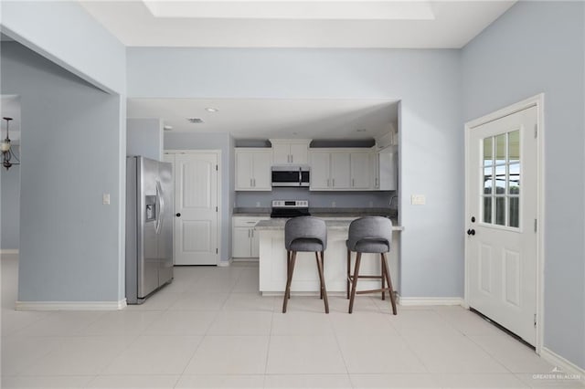 23309 Tangerine Ave, Harlingen, TX 78552 - kitchen with stainless steel appliances, a kitchen breakfast bar, a peninsula, white cabinets, and recessed lighting