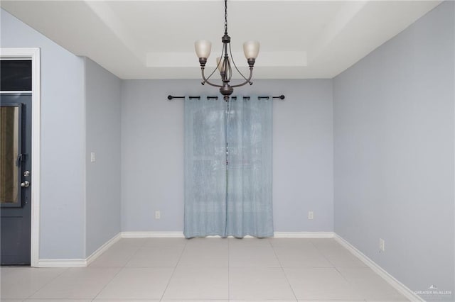 23309 Tangerine Ave, Harlingen, TX 78552 - spare room featuring a raised ceiling, a chandelier, and light tile patterned floors