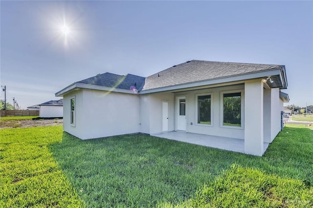 rear view of property with a patio and a yard