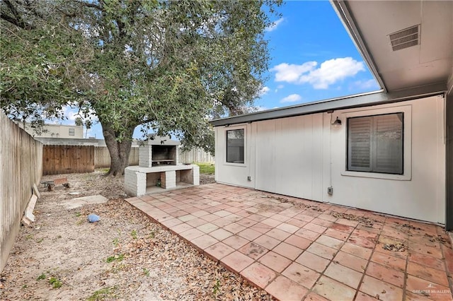 view of patio / terrace featuring exterior kitchen and a fenced backyard