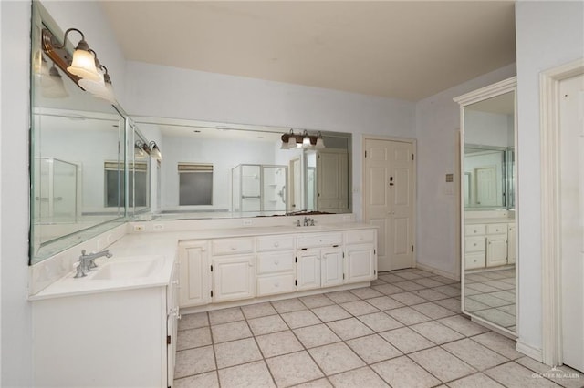 full bathroom featuring double vanity, tile patterned flooring, and a sink