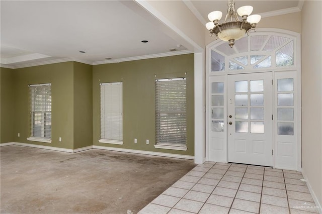 entrance foyer featuring a chandelier, crown molding, baseboards, and tile patterned floors