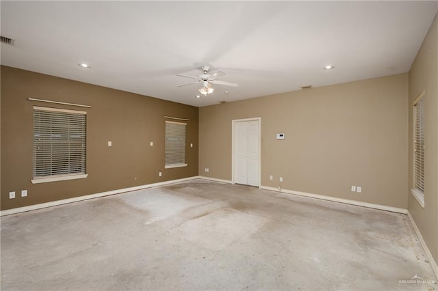 empty room with a ceiling fan, baseboards, concrete flooring, and recessed lighting