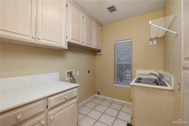 clothes washing area with cabinet space, visible vents, a sink, washer hookup, and electric dryer hookup