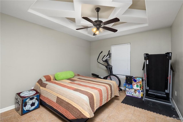 tiled bedroom featuring a raised ceiling and ceiling fan