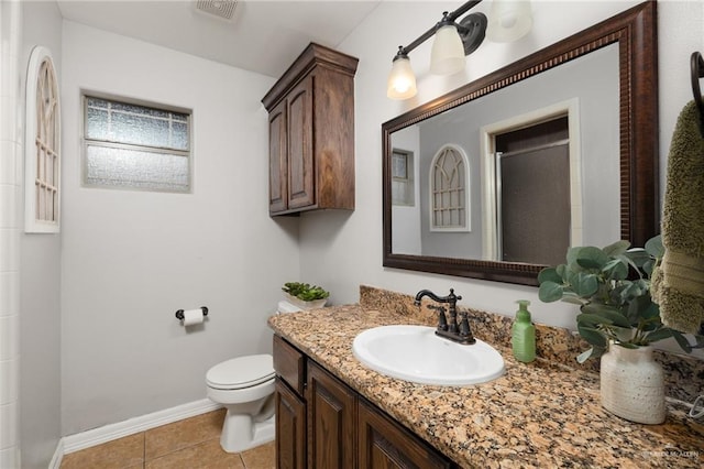 bathroom with a shower, tile patterned flooring, vanity, and toilet