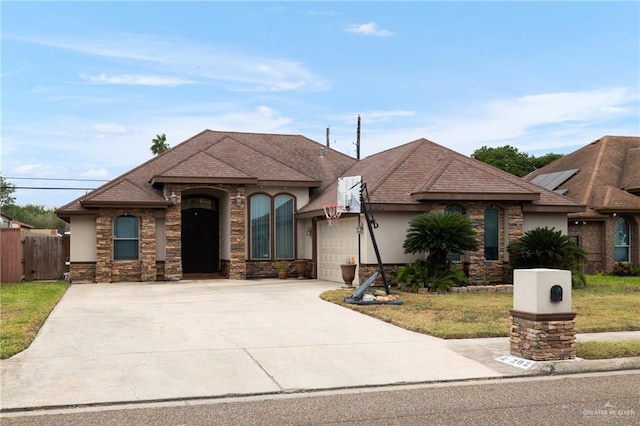 view of front of house with a front yard and a garage