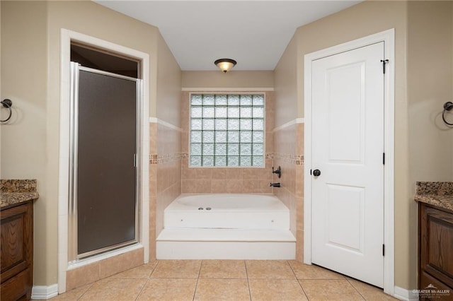 bathroom with tile patterned floors, vanity, and independent shower and bath