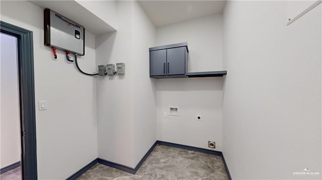 laundry room featuring water heater, cabinets, hookup for a washing machine, and hookup for an electric dryer