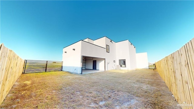 rear view of property featuring central AC