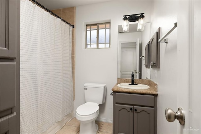 bathroom with vanity, toilet, and tile patterned flooring