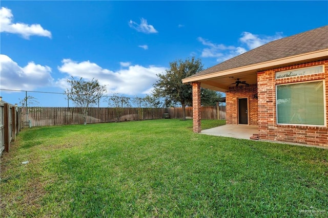 view of yard with a patio and ceiling fan