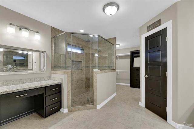 bathroom featuring vanity and a shower with door