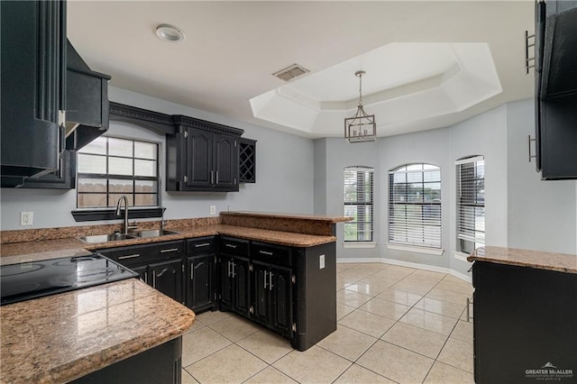 kitchen with a raised ceiling, sink, decorative light fixtures, light tile patterned floors, and a notable chandelier