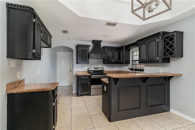 kitchen with a kitchen breakfast bar, electric stove, custom range hood, light tile patterned flooring, and kitchen peninsula