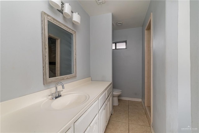 bathroom with tile patterned floors, vanity, and toilet