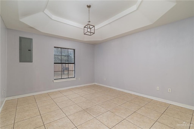 spare room with light tile patterned floors, electric panel, and a tray ceiling