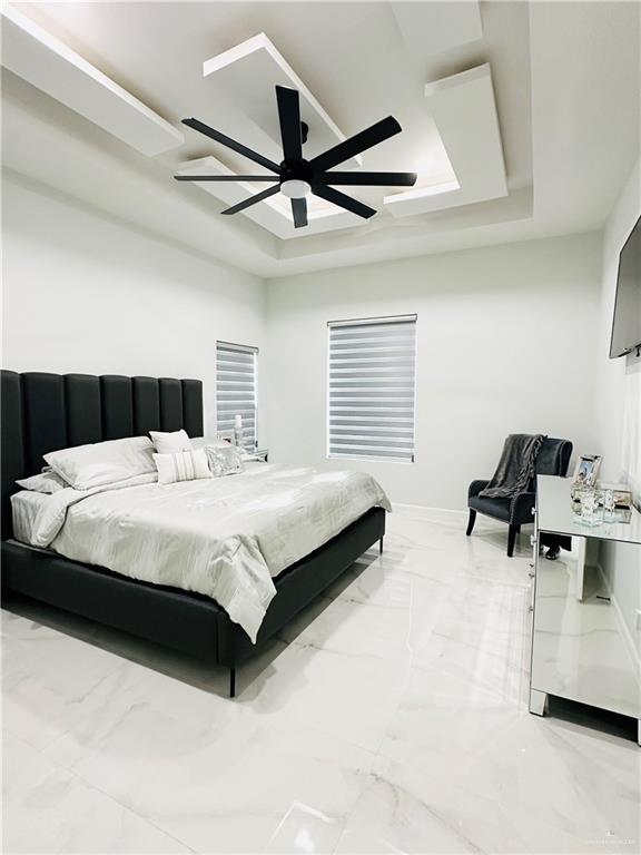 1509 Giselle St, Mission, TX 78574 - bedroom with marble finish floors, a raised ceiling, ceiling fan, and baseboards