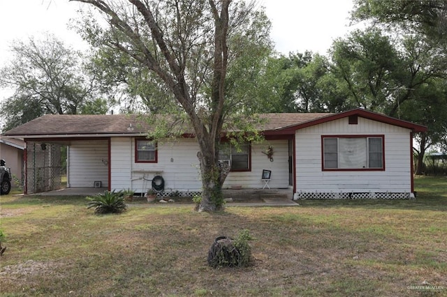 view of front of home with a front yard and a carport