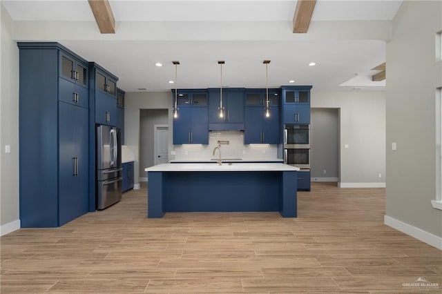 kitchen with beam ceiling, stainless steel appliances, decorative backsplash, and light countertops