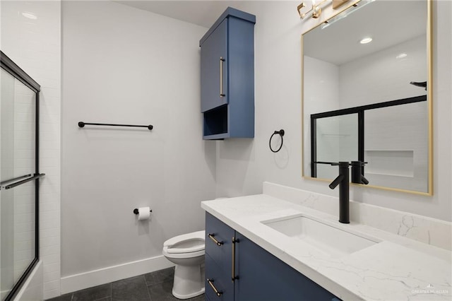 bathroom with vanity, tile patterned flooring, toilet, and baseboards