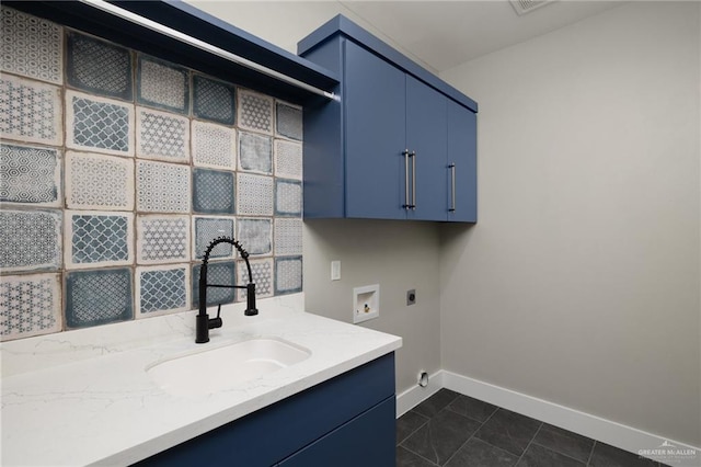 laundry area with washer hookup, cabinet space, a sink, electric dryer hookup, and baseboards