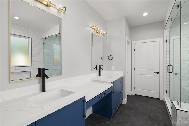 full bathroom with double vanity, tile patterned flooring, a sink, and a shower stall