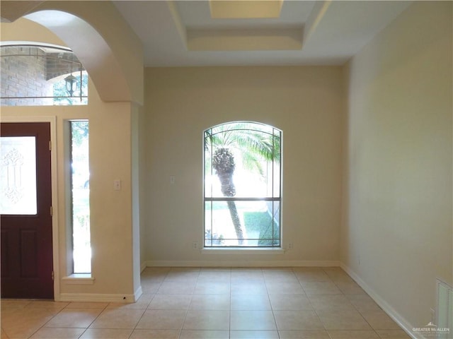3519 Aspen Dr, Edinburg, TX 78542 - foyer entrance featuring light tile patterned floors, a raised ceiling, and arched walkways