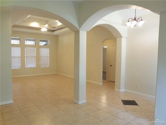 3519 Aspen Dr, Edinburg, TX 78542 - unfurnished room featuring light tile patterned floors, ceiling fan, a raised ceiling, arched walkways, and a chandelier