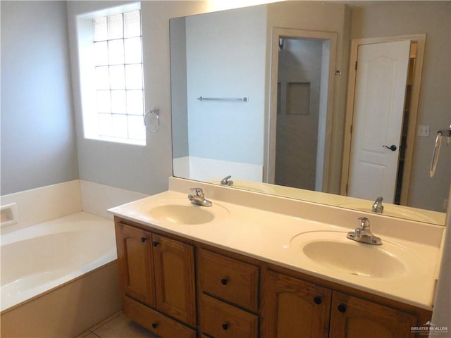 bathroom with tile patterned flooring, a bathtub, and vanity