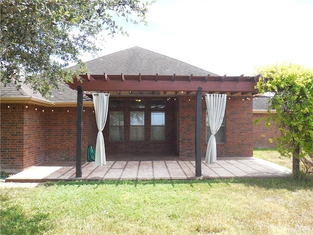 back of house featuring a lawn, a patio area, and a pergola