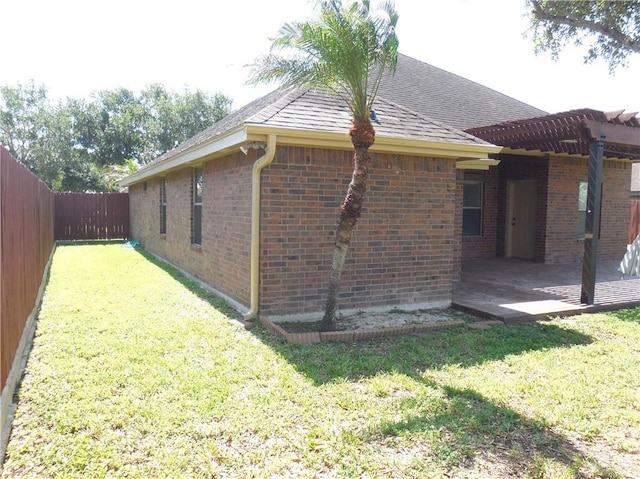 3519 Aspen Dr, Edinburg, TX 78542 - back of house featuring a fenced backyard, brick siding, a patio area, roof with shingles, and a pergola