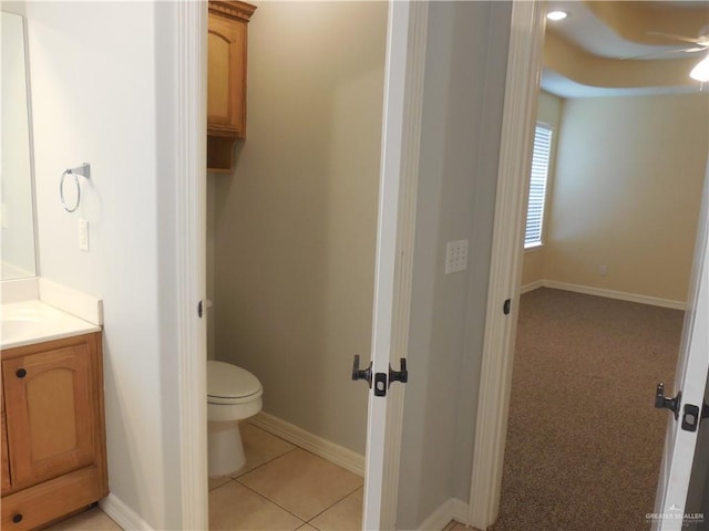 bathroom with tile patterned flooring, vanity, and toilet