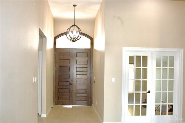 doorway to outside with a chandelier and french doors