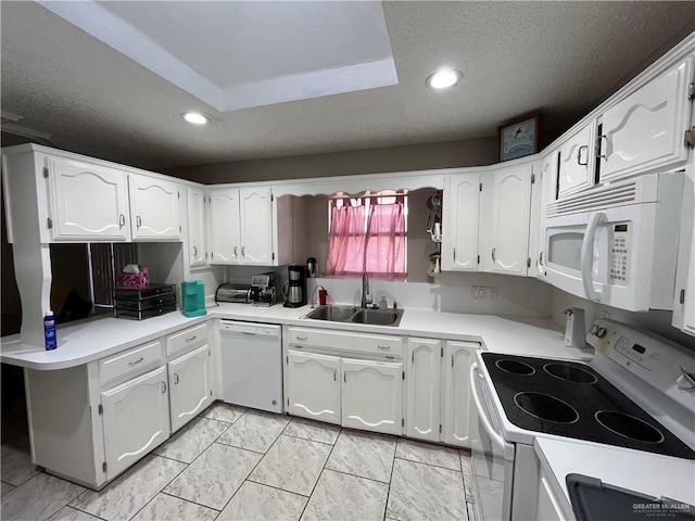 kitchen featuring white cabinetry, sink, white appliances, and a textured ceiling