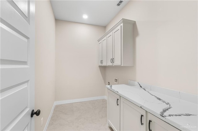 5308 N 42nd St, Mcallen, TX 78504 - laundry area featuring baseboards, washer hookup, visible vents, cabinet space, and marble finish floor