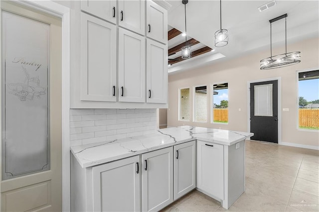 5308 N 42nd St, Mcallen, TX 78504 - kitchen with pendant lighting, tasteful backsplash, a peninsula, visible vents, and light stone counters