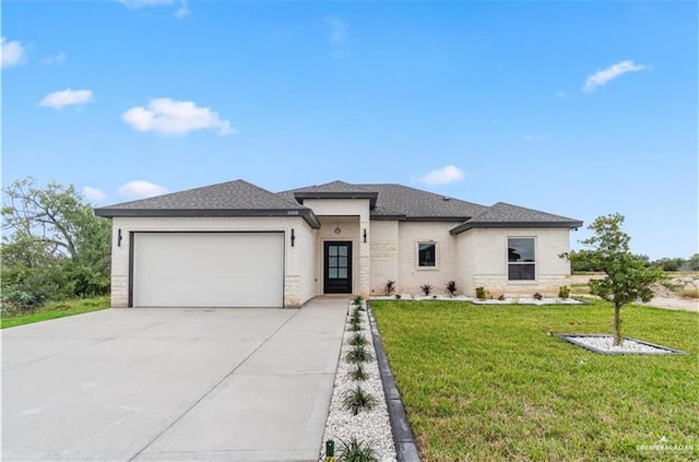 5308 N 42nd St, Mcallen, TX 78504 - prairie-style home featuring a garage, a front yard, driveway, and brick siding