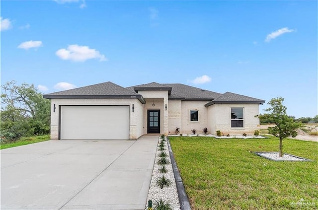 prairie-style home with a garage and a front yard