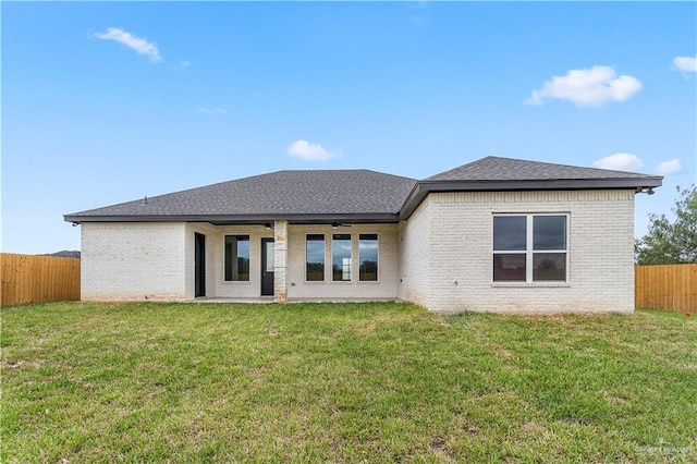 5308 N 42nd St, Mcallen, TX 78504 - back of property with brick siding, a fenced backyard, a yard, and roof with shingles