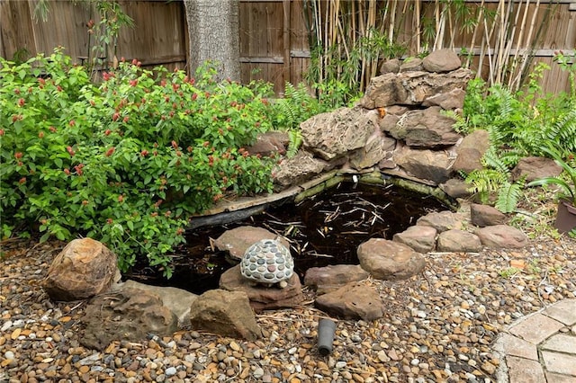 1113 Xanthisma Ave, Mcallen, TX 78504 - details with fence and a small pond