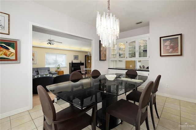 1113 Xanthisma Ave, Mcallen, TX 78504 - dining room with light tile patterned floors, ceiling fan with notable chandelier, visible vents, and baseboards