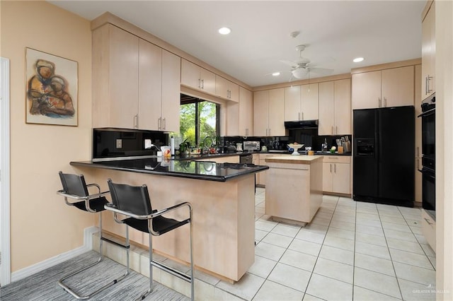 1113 Xanthisma Ave, Mcallen, TX 78504 - kitchen featuring ceiling fan, under cabinet range hood, black appliances, recessed lighting, and a peninsula