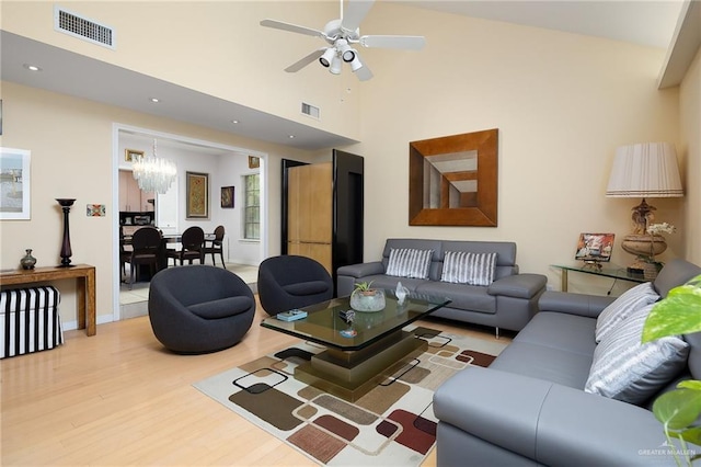 1113 Xanthisma Ave, Mcallen, TX 78504 - living area featuring visible vents, wood finished floors, ceiling fan with notable chandelier, and a high ceiling