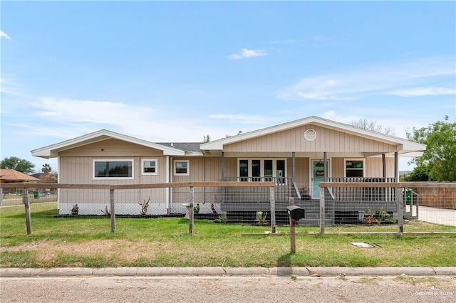 view of front of home with a porch and a front yard